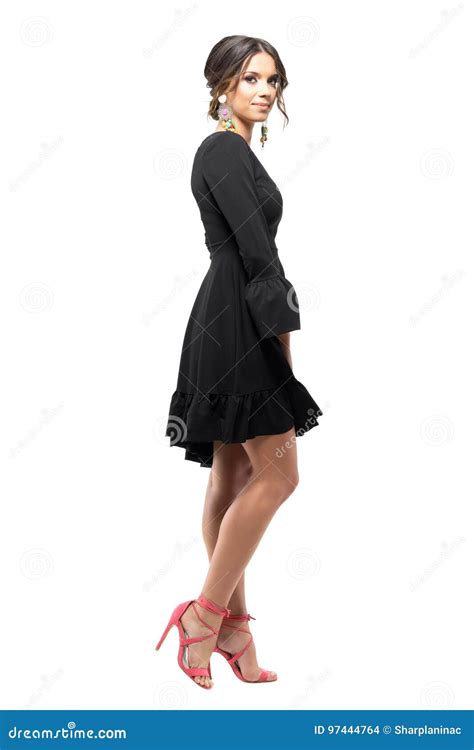 Side View Of Gorgeous Female Fashion Model In Black Dress Smiling At