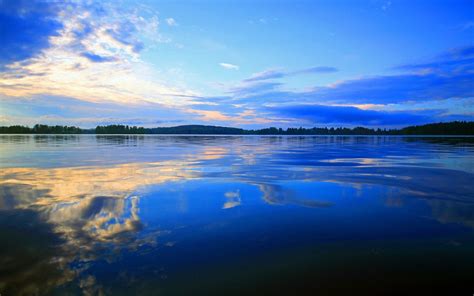 Online Crop Reflection Of White Clouds And Blue Sky On Water Under