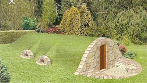 There Is A Small Stone Structure In The Grass With An Open Door On It S