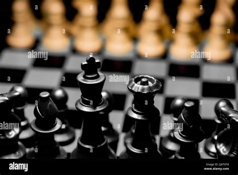 Close Up Of Chess Pieces On A Reflective Mirror Board Surface With A