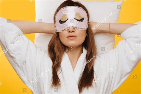 Middle Aged Brunette Woman Lying On Pillow With Hands Behind Head