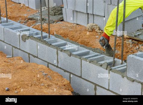 Bricklayers Are Laying Concrete Blocks In Wall In Order To Construct