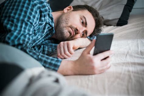 Man Using Phone Lying On The Bed Stock Photo Image Of Insomnia Chat