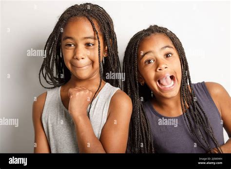 Adorable African Twin Little Girls On Studio Gray Background Doing Some