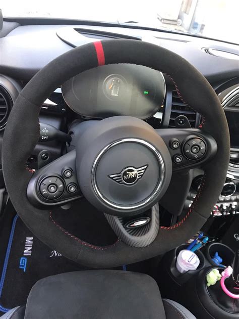 The Interior Of A Car With Steering Wheel Controls