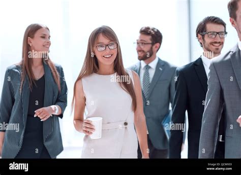 Group Of Business People Passing Through The Office Corridor Stock