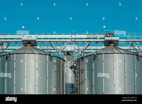 Silver Silos On Agro Processing And Manufacturing Plant Stock Photo Alamy