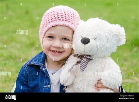 Girl Hugging A Teddy Bear Picnic Stock Photo Alamy