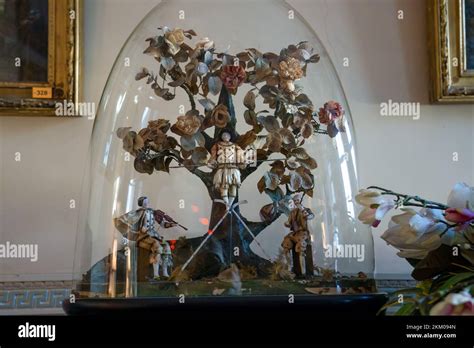 An Antique Glass Dome Display With Miniature Mannequin Models Of A