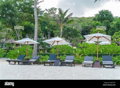 Beautiful Beach Chairs With Umbrella On Tropical White Sand Beach Stock