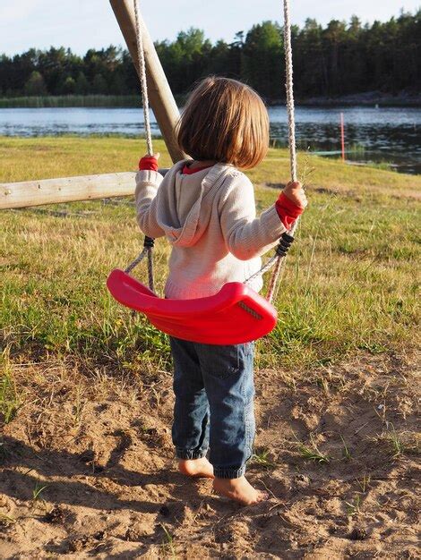 Premium Photo Full Length Of Girl On Swing At Park