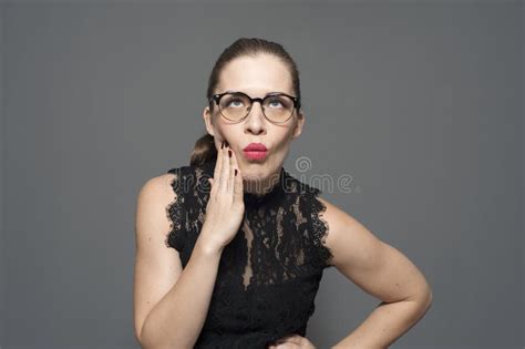 Young Caucasian Woman In Glasses Holds Hands On The Head Posing On A