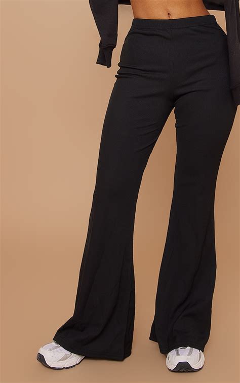 Petite Black Ribbed Flared Trousers Petite Prettylittlething