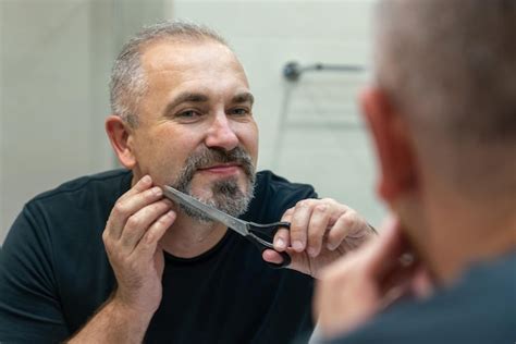 Premium Photo Portrait Of Middleaged Handsome Man Cutting His Beard