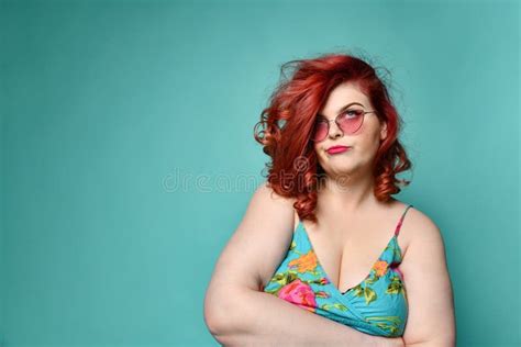 Extra Cool Plus Size Overweight Redhead Lady In Sunglasses Shows A Gesture Sign Finger Gun