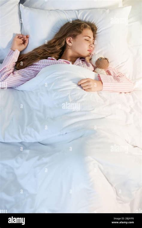 Teenage Girl Sleeping In Bed At Night Stock Photo Alamy