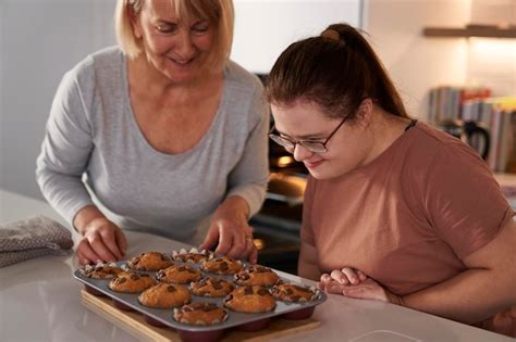 Premium Photo Down Syndrome Woman And Mother About To Eat Homemade