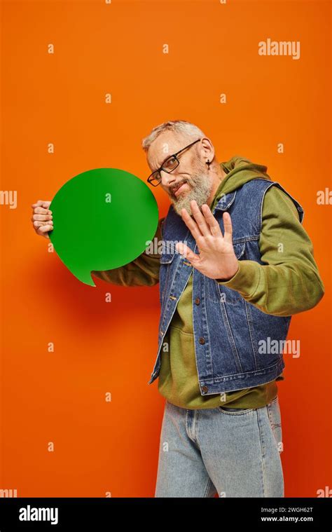 Good Looking Mature Male Model With Glasses Holding Speech Bubble And