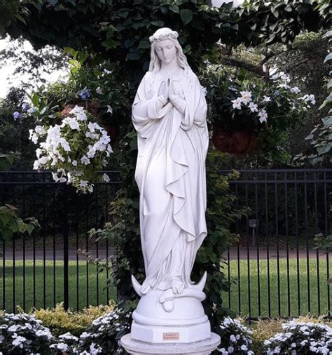 Large Outdoor Mary Statue In Grotto On Church Grounds