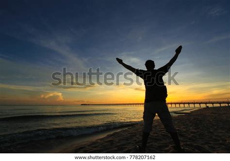 Silhouette Man Hands Raised Beautiful Sunrise Stock Photo