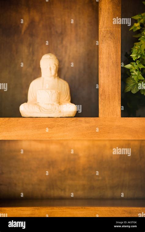 Statue Of Buddha On Shelf Stock Photo Alamy