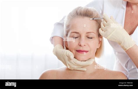 Middle Aged Woman Gets Cosmetic Injection In Her Forehead Hyaluronic