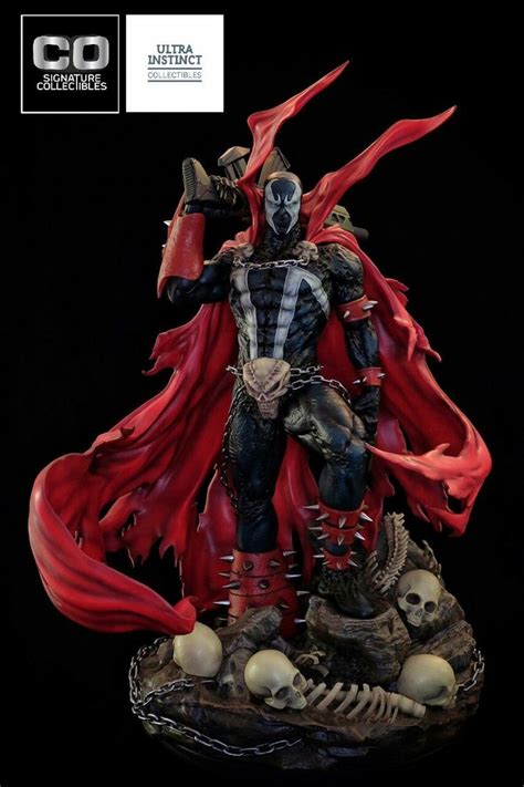 A Statue Of A Demon With Red Cape And Skulls