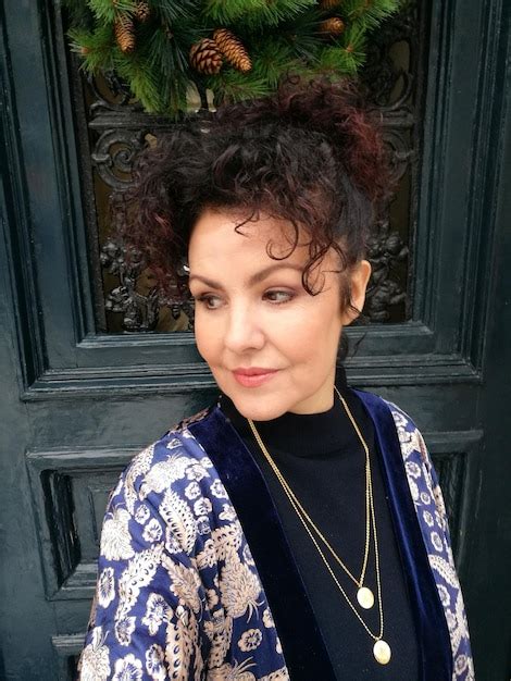 Premium Photo Mature Woman Standing Against Door