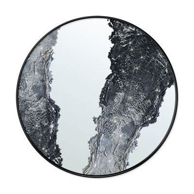 A Round Mirror With An Image Of Trees In The Middle And Snow On The Ground