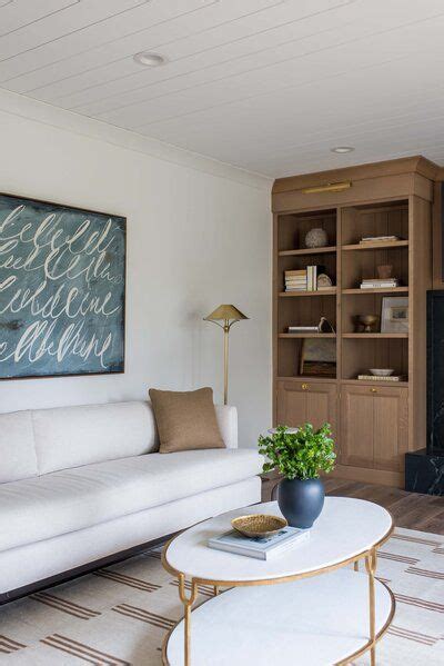 A Living Room Filled With Furniture And A Large Painting On The Wall