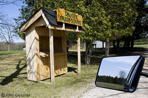 There Is A Small Wooden Structure With A Sign On It