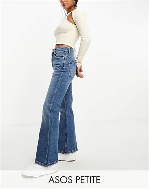Asos Design Petite Mid Rise Flare Jeans In Mid Blue Asos