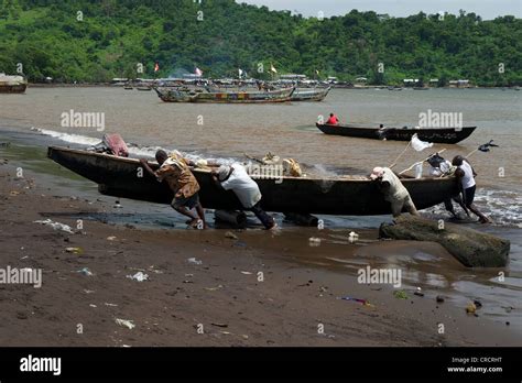 Fishermen Pulling A Boat Ashore Limbe Cameroon Africa Stock Photo