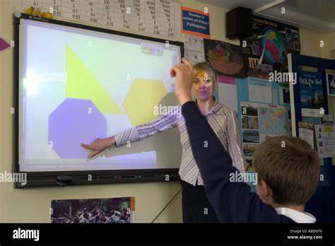 Teacher Demonstrating On Interactive Whiteboard Stock Photo Alamy