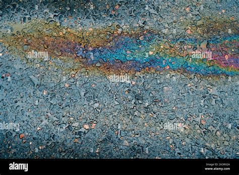 Multi Colored Oil Spill On Asphalt Road Abstract Background Stock