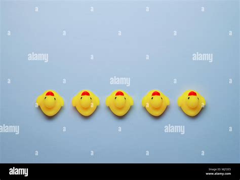 Multiple Yellow Rubber Ducks Arranged In A Line Pointing In A Same