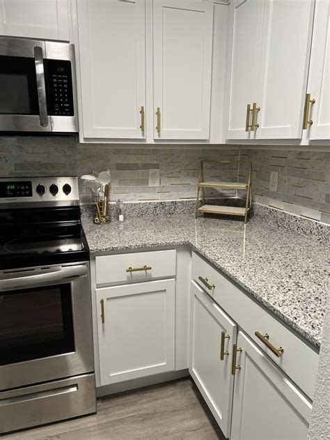 Modern White Kitchen with Marble Countertops