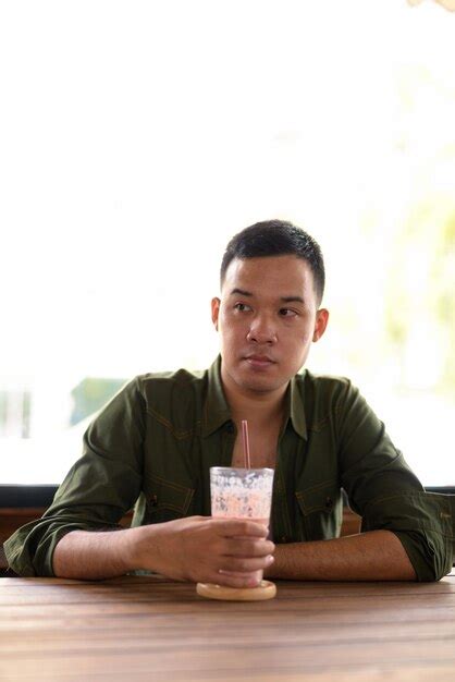 Premium Photo Portrait Of Mature Man Drinking Glass On Table