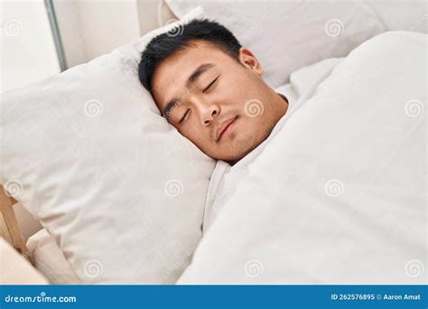 Young Chinese Man Lying On Bed Sleeping At Bedroom Stock Image Image