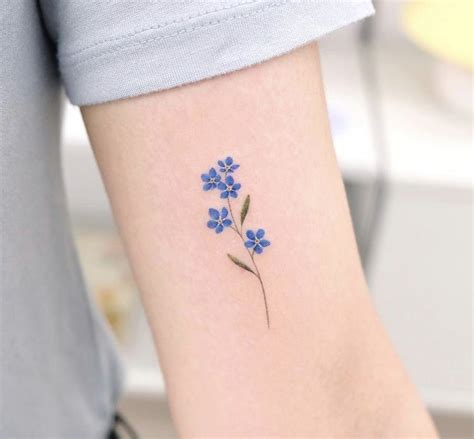 Small Blue Flower Tattoo On Arm