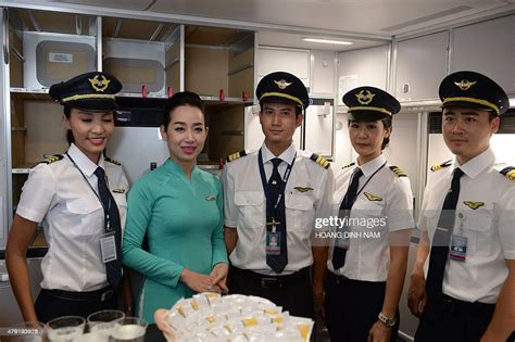 Vietnam Airlines Pilots And A Flight Attendant Wearing New Uniforms