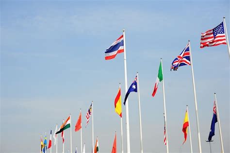 Premium Photo Low Angle View Of Various Flags Waving Against Sky