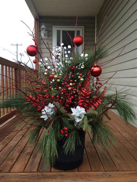 A Potted Plant Sitting On Top Of A Wooden Deck Covered In Christmas