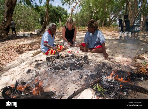 A Tourist And Two Aboriginal Women From The Mv Pikkuw Sit Around A