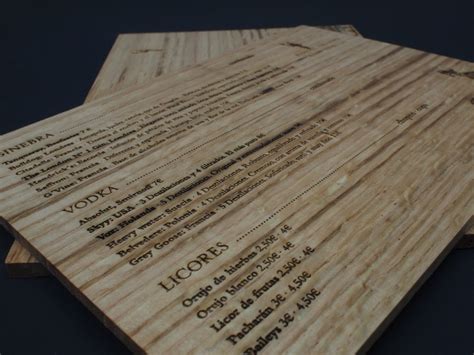 Wooden Cutting Boards With Names On Them Sitting Next To Each Other In