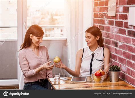 Businesswoman Sharing Food With Friend Stock Photo Bnenin 170137624