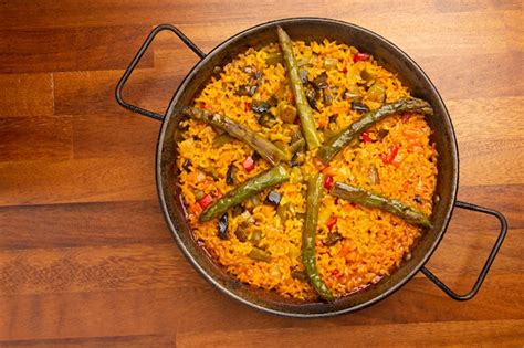 Premium Photo | Vegetable paella rice with vegetables in paella pan, on ...