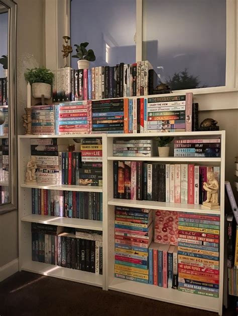 A Book Shelf Filled With Lots Of Books Next To A Window