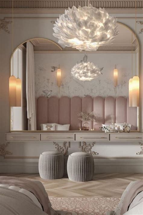 A Large Mirror Sitting Above A Bed Next To A White Table With Two Vases