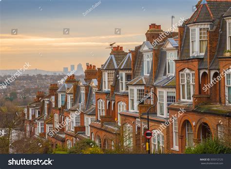 Typical British Brick Houses On A Cloudy Morning With Sunrise And